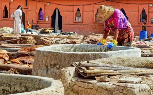 Worker processing hides at a traditional leather tannery in Morocco