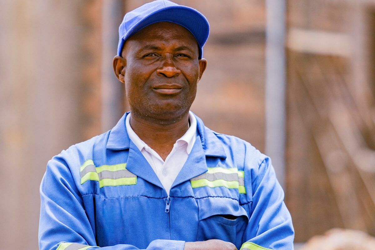A portrait of a factory worker in a blue uniform