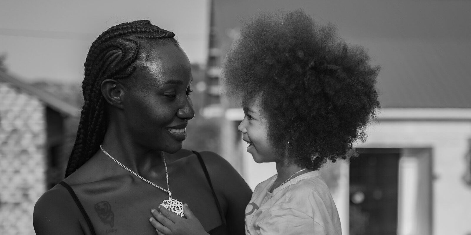 Mother holding her young child, illustrating a testamentary trust set up through a will to provide for children in Kenya