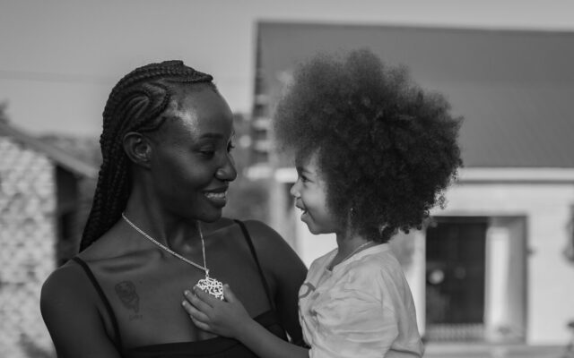 Mother holding her young child, illustrating a testamentary trust set up through a will to provide for children in Kenya