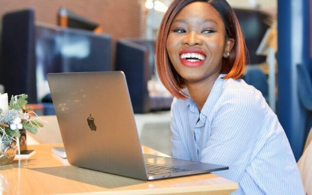 Trademark clearance at KIPI: African businesswoman researching a brand on her laptop