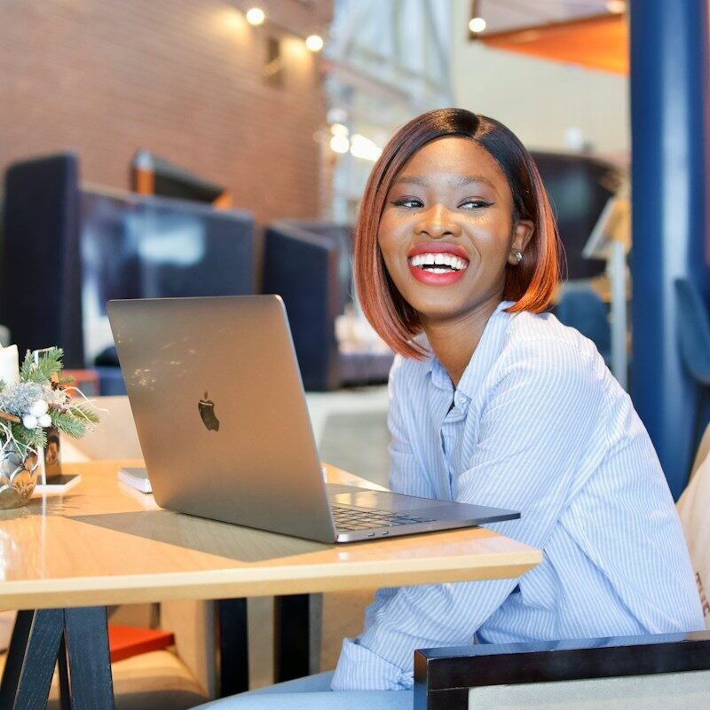 Trademark clearance at KIPI: African businesswoman researching a brand on her laptop