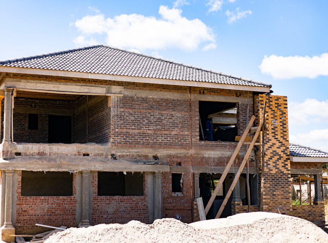 Two-storey brick house under construction illustrating an off-plan property purchase in Kenya