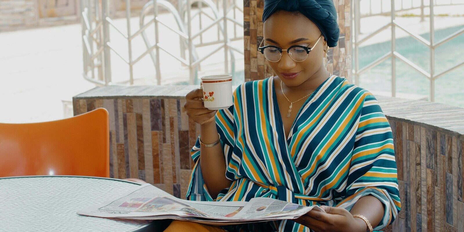 IP in liquidation: African businesswoman reading financial news, representing a creditor or licensee following an insolvent company