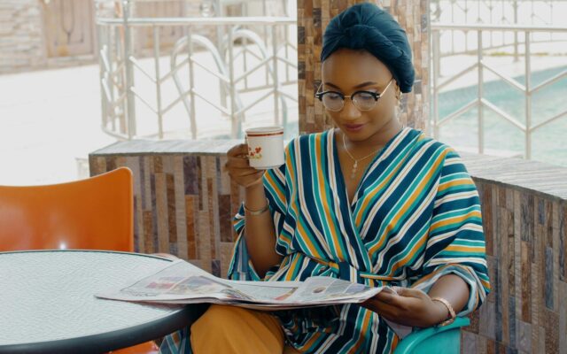 IP in liquidation: African businesswoman reading financial news, representing a creditor or licensee following an insolvent company