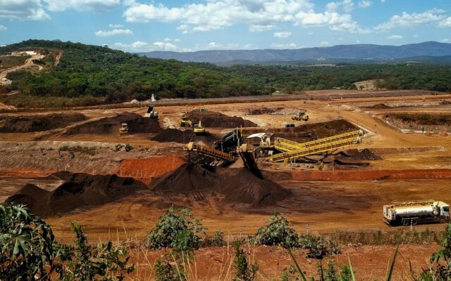 Aerial view of an open pit mine with heavy excavation machinery