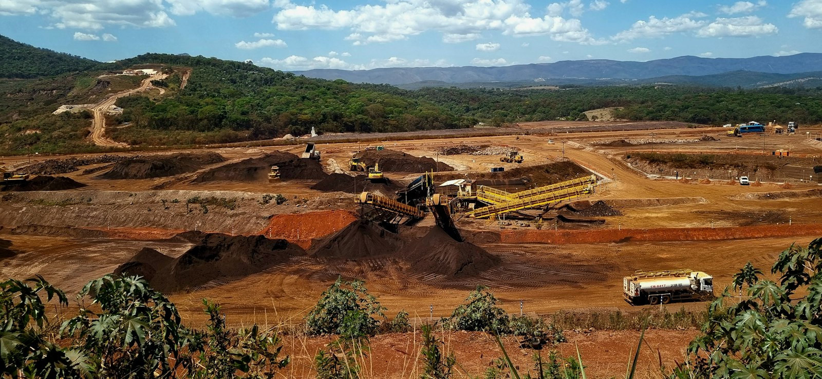 Aerial view of an open pit mine with heavy excavation machinery