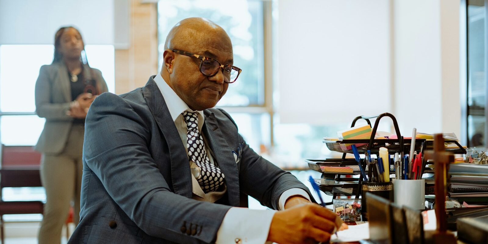 Kenyan executive signing documents at his office desk