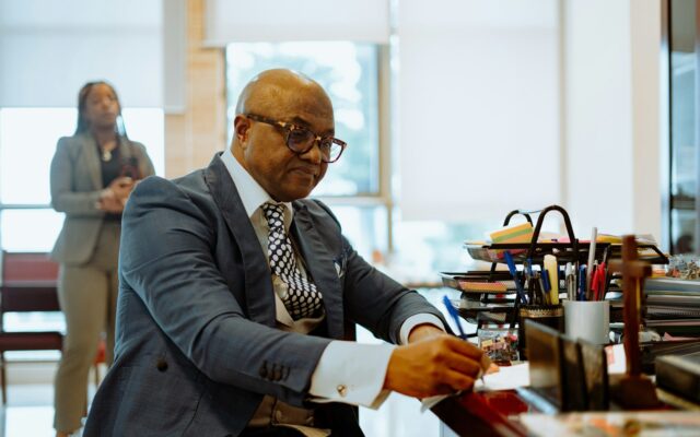 Kenyan executive signing documents at his office desk