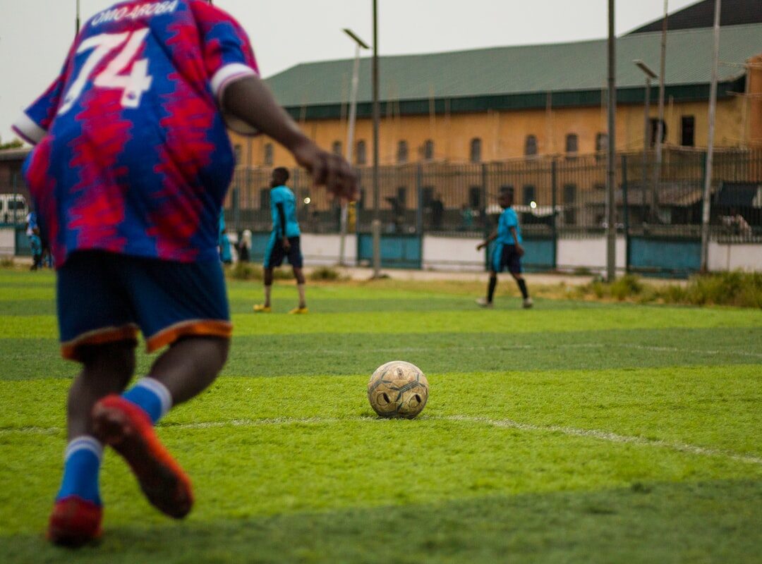 Football player about to kick the ball representing payroll obligations for sports employers in Kenya