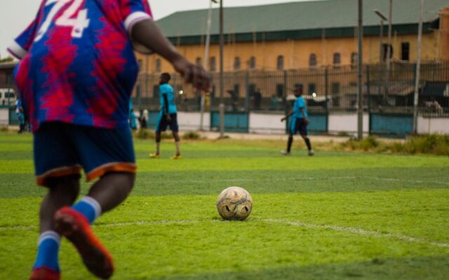 Football player about to kick the ball representing payroll obligations for sports employers in Kenya