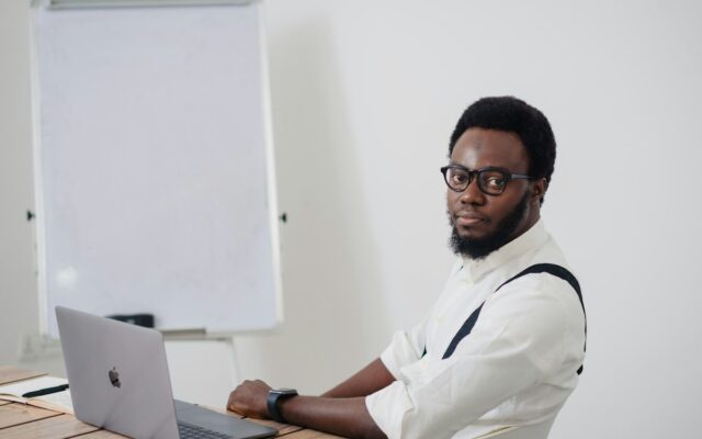 Advisor reviewing estate documents on a laptop for a diaspora beneficiary