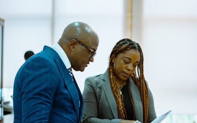 African corporate lawyers reviewing intellectual property due diligence documents in Kenya
