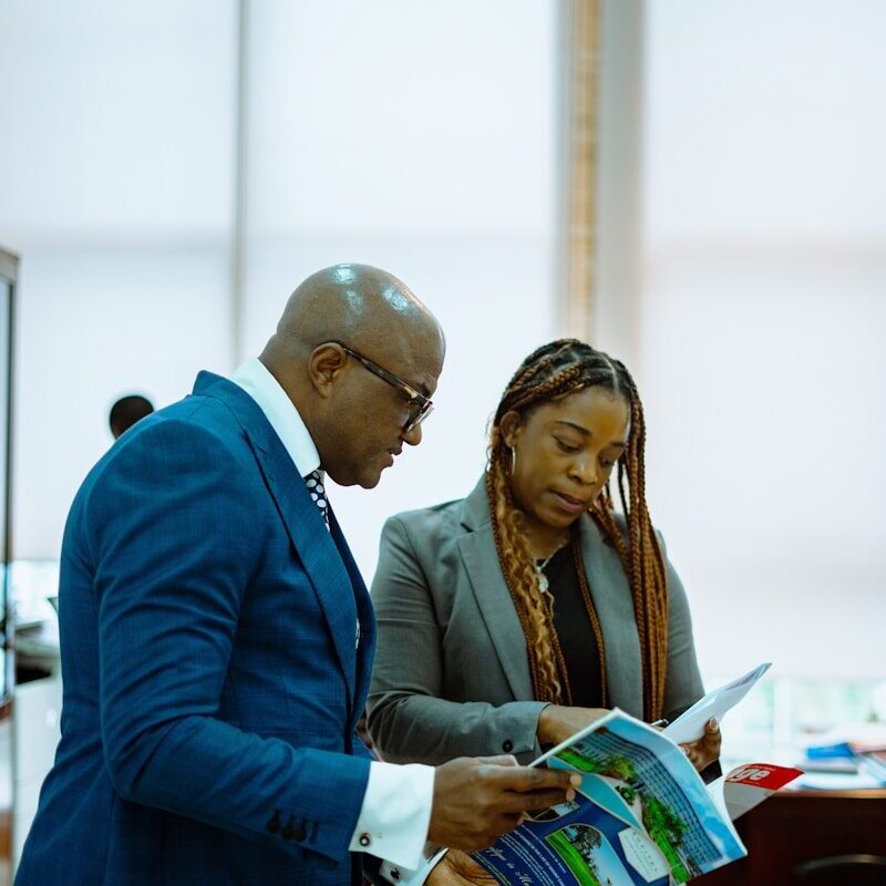 African corporate lawyers reviewing intellectual property due diligence documents in Kenya