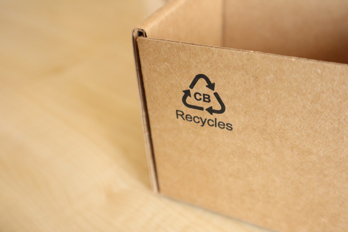 A cardboard box printed with a recycling symbol and claim