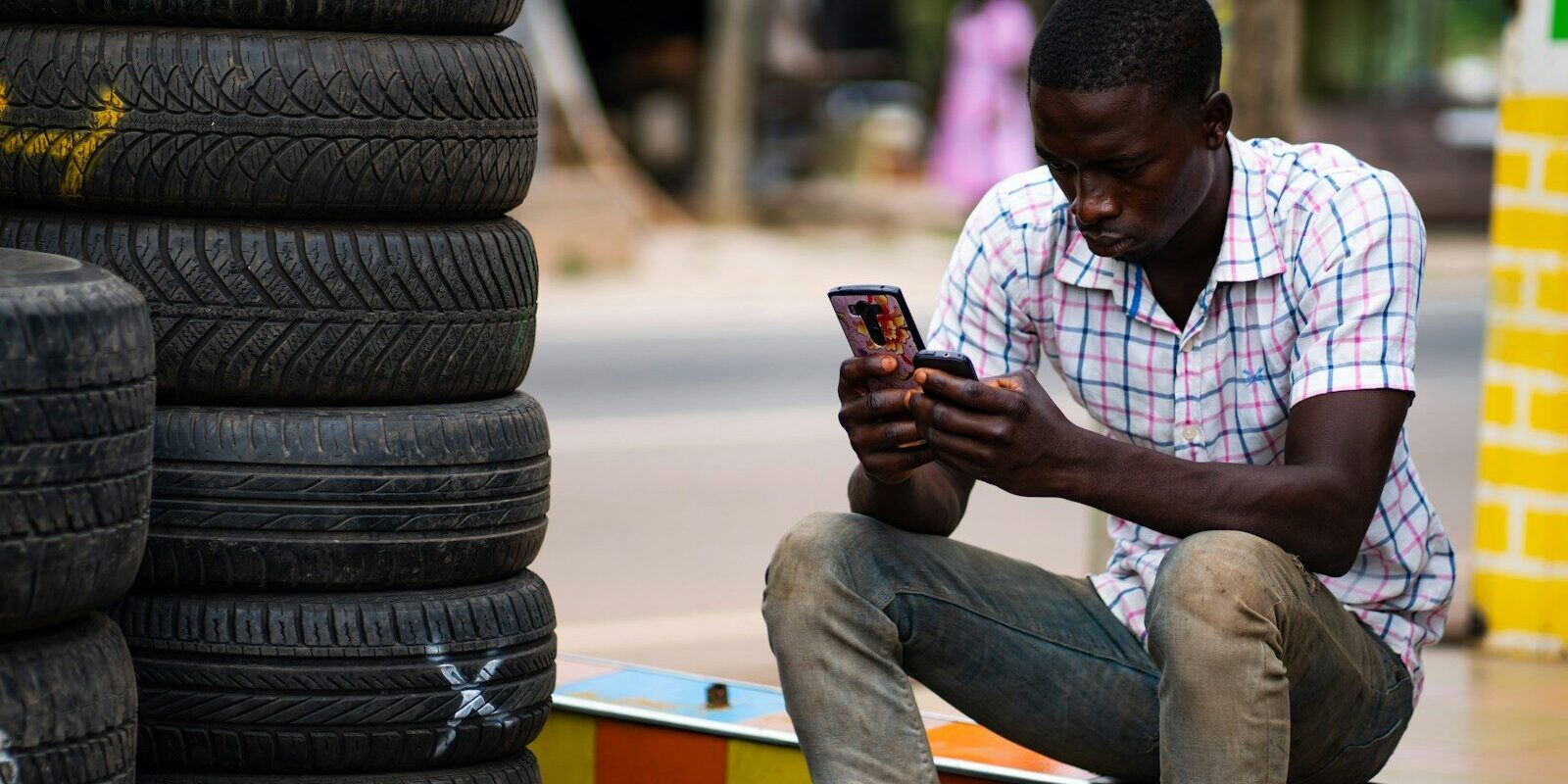 Kenyan digital lending customer checking a mobile phone, illustrating algorithmic credit scoring in everyday borrowing