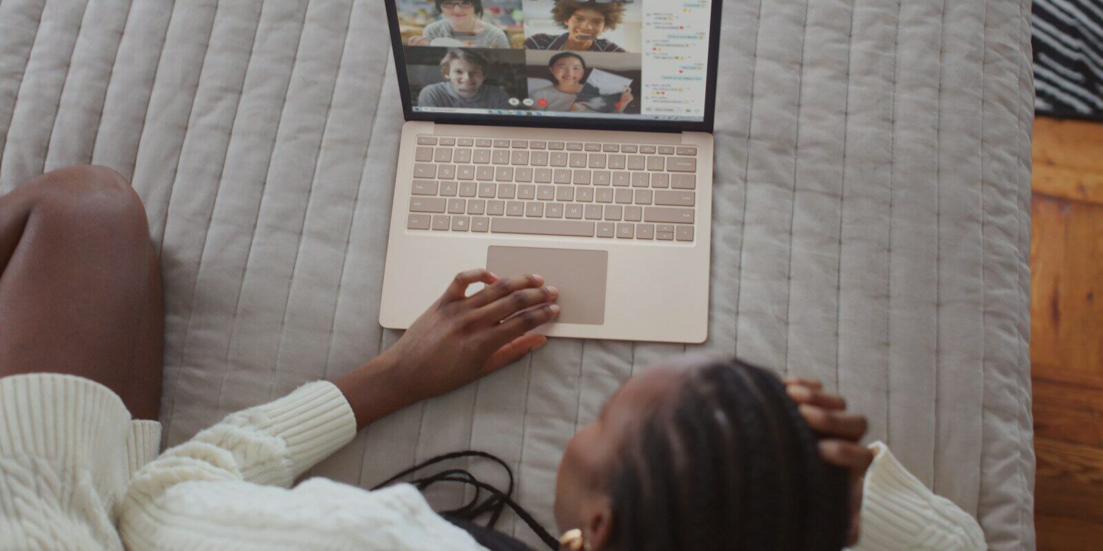 Woman on a video call with family on her laptop, illustrating a diaspora family managing a Kenyan family trust from abroad