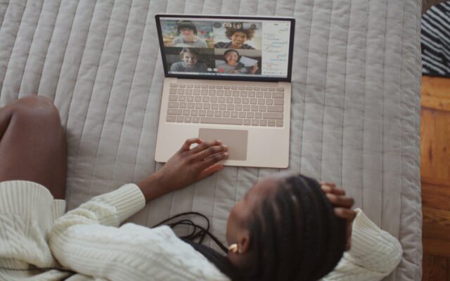 Woman on a video call with family on her laptop, illustrating a diaspora family managing a Kenyan family trust from abroad