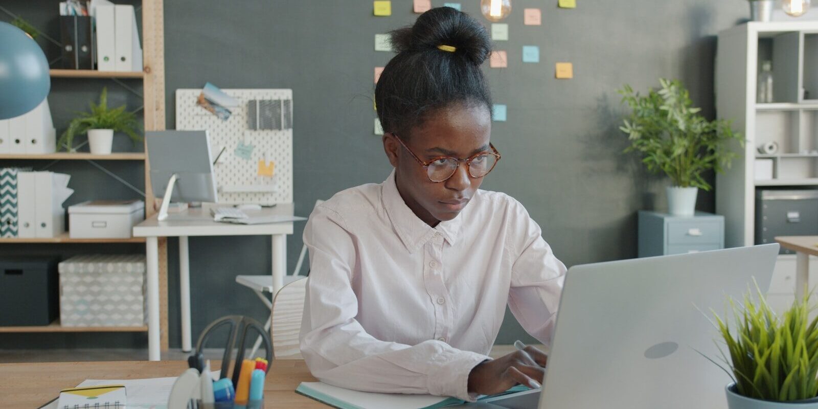 An African professional working on a laptop, representing software-based medical device regulation and compliance