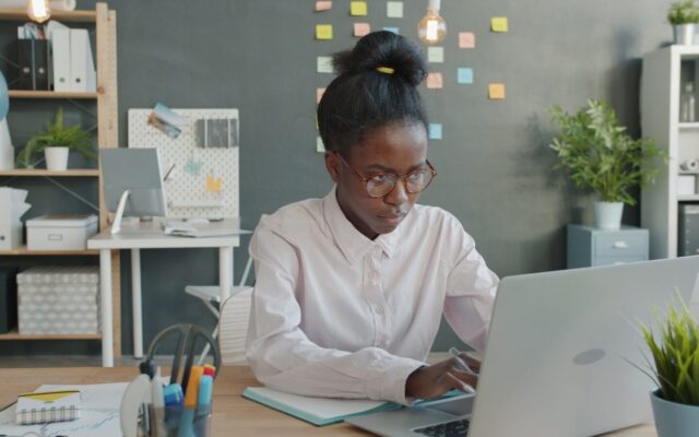 An African professional working on a laptop, representing software-based medical device regulation and compliance