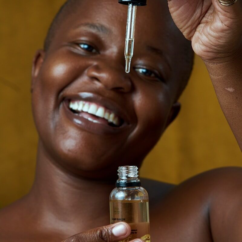 African woman holding a cosmetics skincare product jar in Kenya