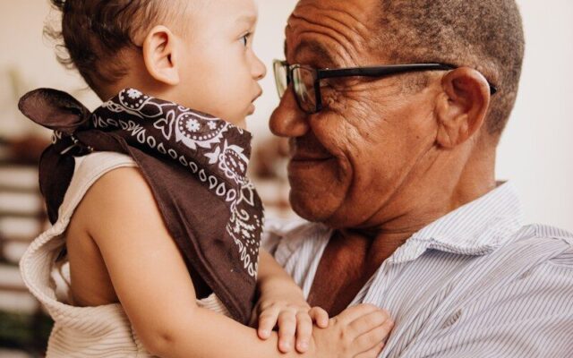 Grandfather holding his grandchild, illustrating a non-charitable purpose trust that preserves family assets across generations in Kenya