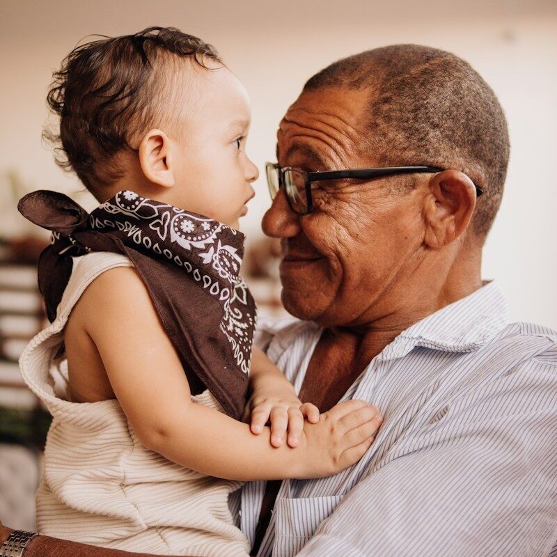 Grandfather holding his grandchild, illustrating a non-charitable purpose trust that preserves family assets across generations in Kenya