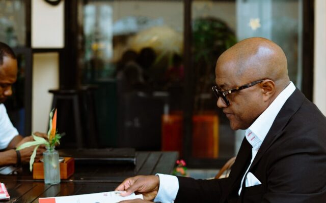 A businessman reviewing documents at a table, representing the regulatory and compliance review process for medical device software
