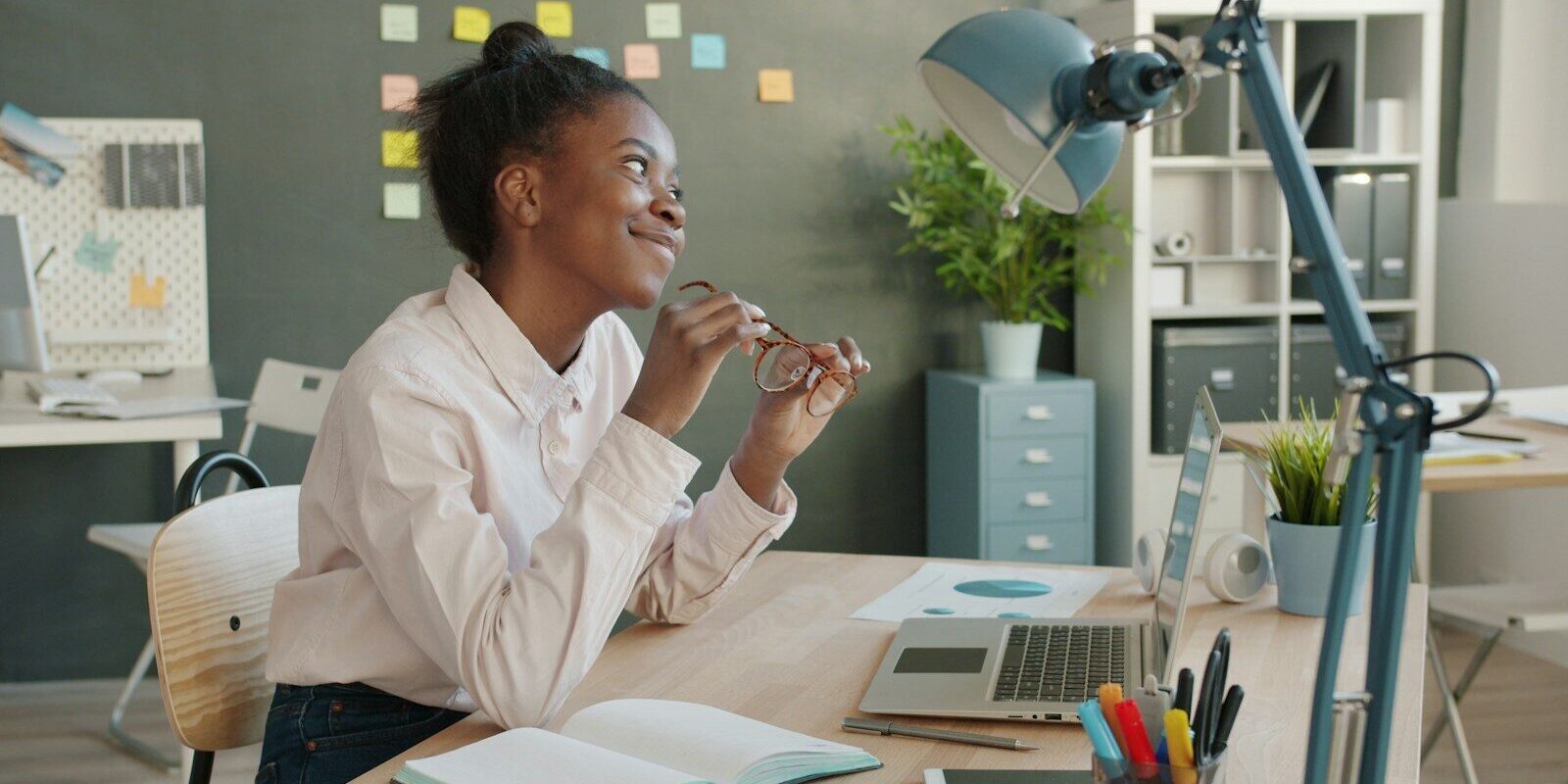 African professional reviewing reports and documents at her desk, representing NCPWD reporting and tax deduction compliance under Kenya's PWD Act