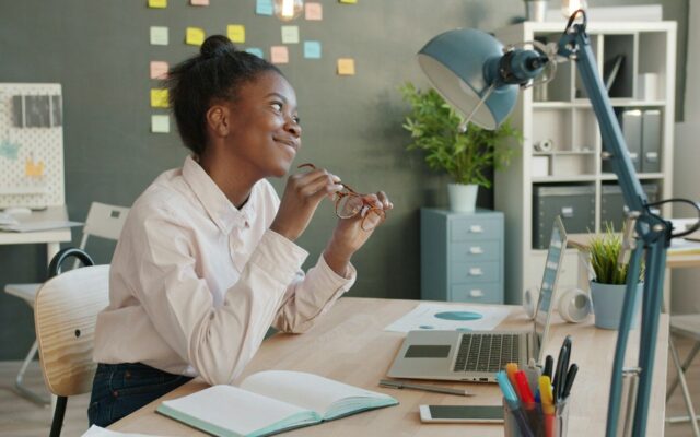 African professional reviewing reports and documents at her desk, representing NCPWD reporting and tax deduction compliance under Kenya's PWD Act